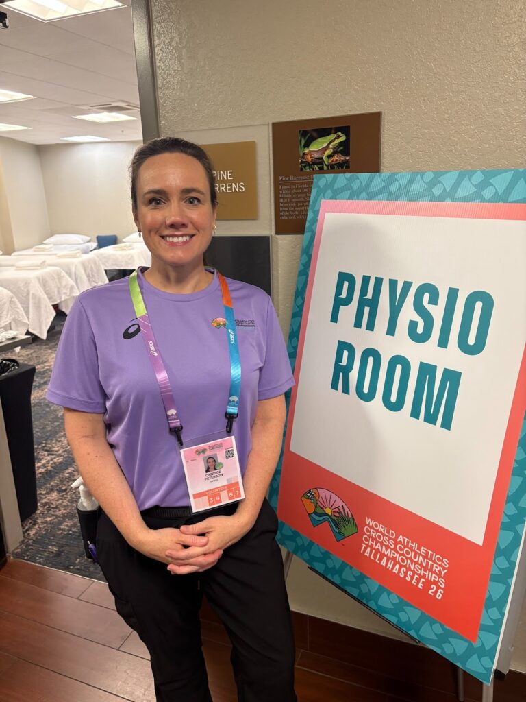 LMT and founder of Restorative Path mobile massage therapists in Tallahassee is shown with her setup at the World Athletics Cross Country Championships